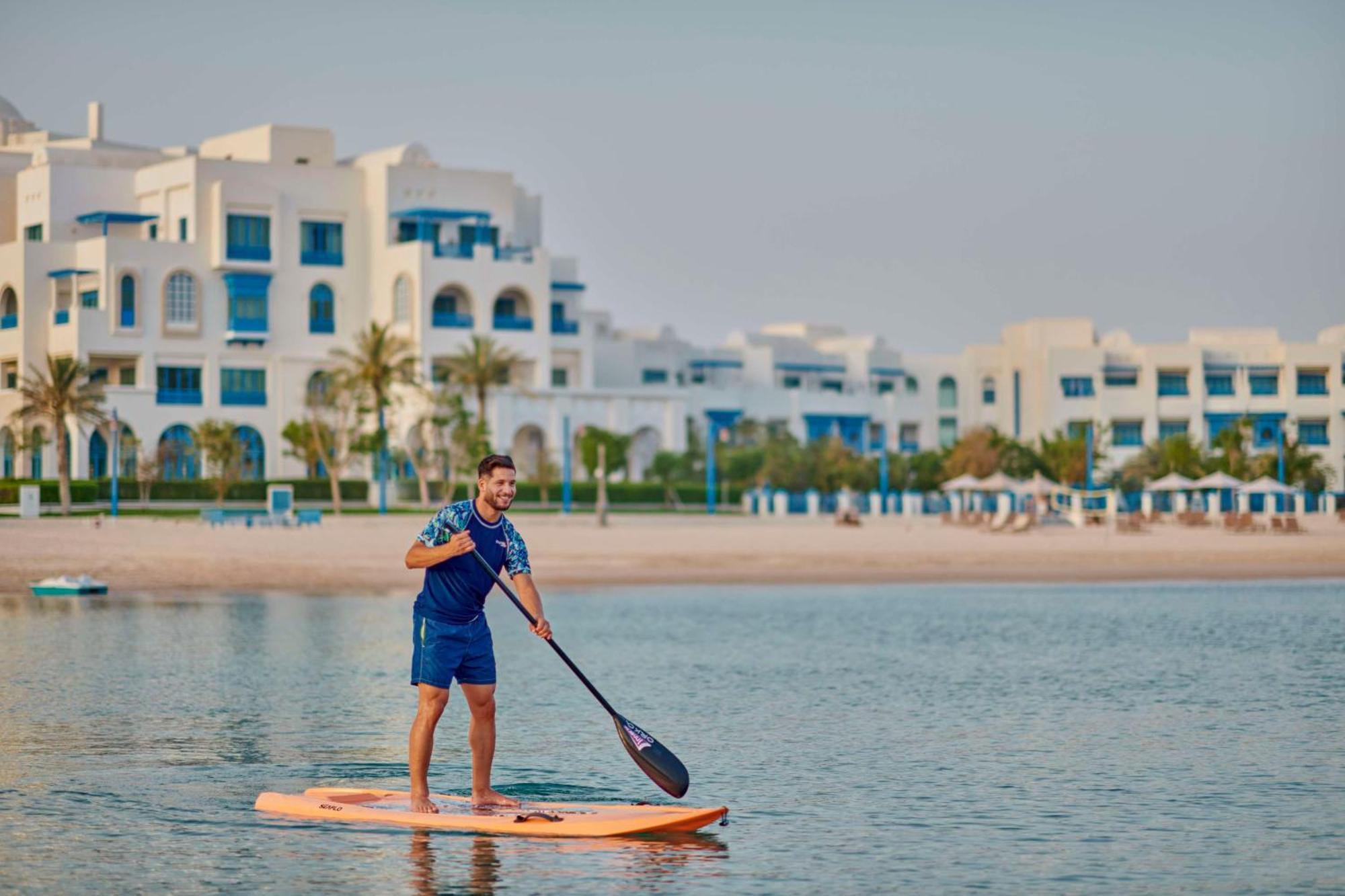 Hilton Salwa Beach Resort And Villas Abu Samra Exterior foto Stand Up Paddle Boarding at Al Habtoor Polo & Equestrian Club